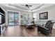 Cozy living room with a ceiling fan and sliding glass doors leading to a screened-in patio at 12462 Rangeland Blvd, Odessa, FL 33556