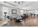 Open-concept living room with gray couches and seamlessly connected to the modern kitchen, perfect for modern living at 12462 Rangeland Blvd, Odessa, FL 33556