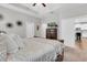 Spacious bedroom with a view of an open floorplan, dark wood dresser, and a king size bed with a decorative blanket at 12462 Rangeland Blvd, Odessa, FL 33556