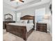 Well-lit bedroom with dark wood furniture, a large bed, and windows offering serene views, creating a cozy retreat at 12462 Rangeland Blvd, Odessa, FL 33556