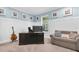 Cozy home office with natural light, board and batten trim, comfortable seating, and neutral color scheme at 12462 Rangeland Blvd, Odessa, FL 33556