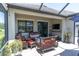 Outdoor patio featuring brick pavers, fire pit, and television at 12462 Rangeland Blvd, Odessa, FL 33556