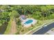 Aerial view of community pool, gazebo, hot tub, with surrounding landscaping at 1339 Queen Anne Dr # C, Palm Harbor, FL 34684