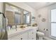 Well-lit bathroom featuring a dual sink vanity, decor, and a tub/shower combination at 13749 80Th Ave, Seminole, FL 33776