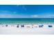 Wide sandy beach with umbrellas, beachgoers, and crystal clear ocean views at 13749 80Th Ave, Seminole, FL 33776