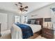 Cozy bedroom with a ceiling fan, bedside tables, a comfortable bed, and beach-themed decor at 13749 80Th Ave, Seminole, FL 33776