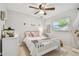 Bedroom with a ceiling fan, a white framed bed and dresser and plenty of natural light at 13749 80Th Ave, Seminole, FL 33776