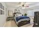 Bright bedroom with a ceiling fan, a queen bed, a map and side tables and plenty of light at 13749 80Th Ave, Seminole, FL 33776