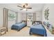 Cozy bedroom featuring two twin beds, a ceiling fan, and window views at 13749 80Th Ave, Seminole, FL 33776