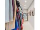Walk-in closet with ample storage space and organization, plus a full length mirror at the end at 13749 80Th Ave, Seminole, FL 33776