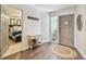 Bright foyer with wood floors, a side table, and hallway leading to the bedroom at 13749 80Th Ave, Seminole, FL 33776