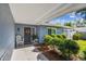 Inviting front porch with rocking chair, decorative wreath, and meticulous landscaping creates a warm welcome at 13749 80Th Ave, Seminole, FL 33776
