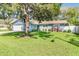 Charming single-story home featuring a lush lawn and mature landscaping with a pergola in a tranquil setting at 13749 80Th Ave, Seminole, FL 33776