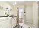 Clean laundry room with washer, dryer, nautical decor, and tile flooring at 13749 80Th Ave, Seminole, FL 33776