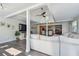 Bright living room featuring plank flooring, ship lap, beamed ceilings, and an open concept design at 13749 80Th Ave, Seminole, FL 33776
