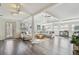Bright and airy living room with wood floors, a large sectional, and ample natural light at 13749 80Th Ave, Seminole, FL 33776