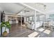 Open concept living room featuring beamed ceilings, plank flooring, and seamless flow to the kitchen at 13749 80Th Ave, Seminole, FL 33776