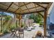 Charming backyard patio with a wooden gazebo and outdoor furniture set at 13749 80Th Ave, Seminole, FL 33776