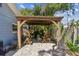 Backyard wooden gazebo with outdoor furniture and landscaped surroundings at 13749 80Th Ave, Seminole, FL 33776