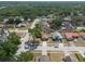 Expansive aerial view of the neighborhood, showcasing the home's location among lush greenery and nearby lake at 1615 Loghill Pl, Brandon, FL 33510