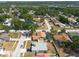 An aerial view showing the home and neighborhood with a pool and nearby green spaces at 1615 Loghill Pl, Brandon, FL 33510