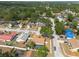 Panoramic aerial view of the neighborhood, highlighting a home with a backyard pool amid lush greenery at 1615 Loghill Pl, Brandon, FL 33510