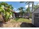 A fenced yard with mature landscaping, a shed, and a screened pool is featured at 1615 Loghill Pl, Brandon, FL 33510