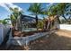 A fenced yard features mature landscaping and a screened pool at 1615 Loghill Pl, Brandon, FL 33510
