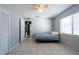 This cozy bedroom features tile floors, a ceiling fan, and a window letting in natural light at 1615 Loghill Pl, Brandon, FL 33510
