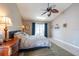 Light-filled bedroom with vaulted ceiling, ceiling fan, and neutral decor at 1615 Loghill Pl, Brandon, FL 33510