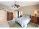 Bedroom with ceiling fan, tile floor, and closet at 1615 Loghill Pl, Brandon, FL 33510
