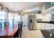 Open dining room features tile floor and view to kitchen and stainless steel refrigerator at 1615 Loghill Pl, Brandon, FL 33510