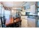 Open dining room with large window, chandelier, and view of kitchen at 1615 Loghill Pl, Brandon, FL 33510