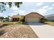 Charming home with stone accents, a two-car garage, and a well-maintained front yard at 1615 Loghill Pl, Brandon, FL 33510