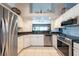 Bright kitchen features stainless steel appliances, white cabinetry, and a tile backsplash at 1615 Loghill Pl, Brandon, FL 33510