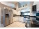 Bright kitchen features stainless steel appliances, white cabinetry, and black granite countertops at 1615 Loghill Pl, Brandon, FL 33510