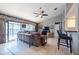 Open-concept living room featuring tile flooring, a ceiling fan and sliding glass doors at 1615 Loghill Pl, Brandon, FL 33510