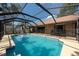 A screened pool is surrounded by mature landscaping and overlooks a fenced yard at 1615 Loghill Pl, Brandon, FL 33510