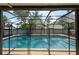 Beautifully screened pool area with a clear view of the pool, yard, and surrounding landscaping at 1615 Loghill Pl, Brandon, FL 33510
