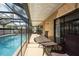 Relax in this covered lanai offering views of the pool and beautiful outdoor space at 1615 Loghill Pl, Brandon, FL 33510
