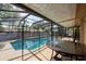 Lanai with seating area provides shade and views of the pool and surrounding landscaping at 1615 Loghill Pl, Brandon, FL 33510