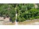 Aerial shot of a gravel driveway winding through a lush, green landscape, showcasing the property's natural surroundings at 1616 Lightfoot Rd, Wimauma, FL 33598