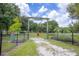 Gated entrance to Sundance Park with lush greenery, providing a serene and private community space at 1616 Lightfoot Rd, Wimauma, FL 33598