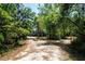 Secluded property with a stilt home nestled among mature trees and foliage, providing a peaceful setting at 1616 Lightfoot Rd, Wimauma, FL 33598