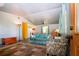 Inviting living room with ample seating, featuring neutral walls and wood-look floors, creating a cozy atmosphere at 1616 Lightfoot Rd, Wimauma, FL 33598