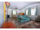 Bright living area showcasing neutral walls, wood-look floors, and comfortable furniture, creating a welcoming space at 1616 Lightfoot Rd, Wimauma, FL 33598