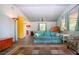 Spacious living room with a comfortable sofa, neutral decor, and a glimpse of the adjacent kitchen and dining area at 1616 Lightfoot Rd, Wimauma, FL 33598