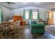 Cozy living room featuring hardwood floors, rolltop desk, and quaint furnishings at 1616 Lightfoot Rd, Wimauma, FL 33598