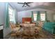 Bright living room showcases natural light, ceiling fan, and flexible seating arrangements at 1616 Lightfoot Rd, Wimauma, FL 33598
