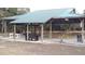 Outdoor pavilion with picnic tables, hot tub, and grill for gatherings under the covered structure at 1616 Lightfoot Rd, Wimauma, FL 33598